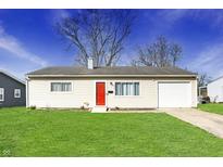 Charming single-story home with a well-maintained lawn and a bright red front door at 676 Nelson Dr, Mooresville, IN 46158