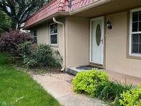 Charming home featuring a front entrance surrounded by lush green landscaping at 8345 Paso Del Norte Ct, Indianapolis, IN 46227