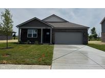 Charming single-Gathering home featuring a brick facade, attached garage, and freshly laid lawn at 915 Saddlebrook Farms Blvd, Whiteland, IN 46184