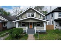 Charming two-story home features a well-maintained lawn and a welcoming front porch at 926 N Dearborn St, Indianapolis, IN 46201