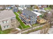 Detailed aerial view of two-story home featuring lush landscaping and backyard patio at 953 Harrison St, Indianapolis, IN 46202