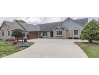 Charming brick home with a spacious driveway and a well-manicured front yard at 1021 Hudson Bay Dr, Greenwood, IN 46142