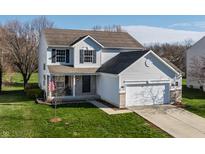 Charming two-story home featuring a well-manicured lawn, attached garage, and welcoming front porch at 11124 Deer Valley Dr, Indianapolis, IN 46229