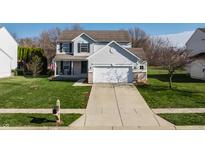 Inviting two-story home with a manicured lawn, an attached garage, and a classic mailbox at 11124 Deer Valley Dr, Indianapolis, IN 46229