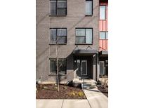 Modern brick condo with front door entry featuring dark trim and landscaping at 1811 Livery Way, Indianapolis, IN 46202