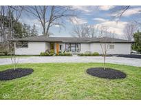 Charming brick ranch with a manicured lawn, fresh mulch, and a gravel driveway at 2138 Kayhill Dr, Anderson, IN 46012