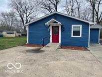 Charming home featuring blue siding, a red front door, and a convenient ramp at 3014 Arbor Ave, Indianapolis, IN 46217