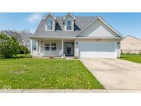 Charming two-story home featuring a front porch, well-maintained lawn, and attached two-car garage at 329 Dogwood Dr, Pendleton, IN 46064