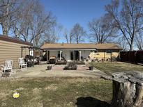 Spacious backyard featuring a patio, fire pit, and well-maintained lawn, perfect for outdoor gatherings at 445 E 1000 N, Alexandria, IN 46001