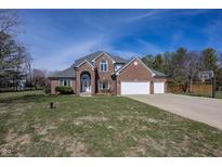 Beautiful two story brick home with a three car garage and well maintained lawn at 4644 S Grassy Ct, New Palestine, IN 46163