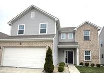 Beautiful two-story home featuring a brick and siding exterior and attached two car garage at 5249 Tanglewood Ln, Whitestown, IN 46075
