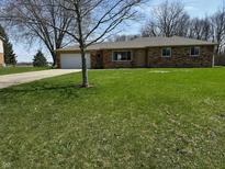 Charming brick ranch home with a large front yard and attached two-car garage at 5630 S Cladwell Dr, Pendleton, IN 46064