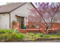 Charming home featuring a spacious wooden deck and beautiful landscaping at 6141 Madison Ave, Indianapolis, IN 46227
