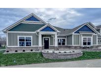 Charming home exterior with stone accents, blue shingles, and a well-manicured lawn at 6222 Fairview Dr, McCordsville, IN 46055