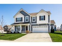 Charming two-story home with a manicured lawn, covered porch, and attached two-car garage at 6767 Sonora Blvd, Brownsburg, IN 46112