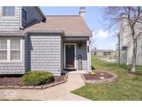 Charming home featuring a welcoming front entrance with a decorative wreath at 7454 Harbour Isle # 158, Indianapolis, IN 46240