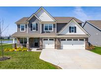 Charming two-story home with attached two-car garage and manicured lawn at 8853 Boylan Pl, Pendleton, IN 46064