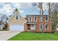 Charming brick and siding home with a well-manicured lawn and attached two car garage at 108 Wesley Cir, Noblesville, IN 46062