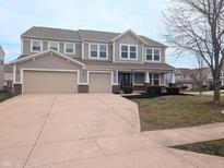 Charming two-story home featuring a three-car garage and well-maintained front yard at 11188 Giddings Pl, Noblesville, IN 46060