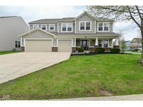 Charming two-story home featuring a well-manicured lawn, a spacious two car garage and a welcoming covered porch at 11188 Giddings Pl, Noblesville, IN 46060