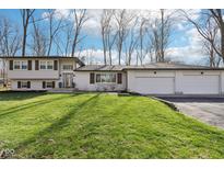 Charming two-story white home with dark shutters and a well-manicured lawn at 11921 Westwood Dr, Carmel, IN 46033