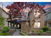 Charming brick home with well-manicured landscaping and covered porch, offering curb appeal and a welcoming entrance at 1537 Carrollton Ave, Indianapolis, IN 46202
