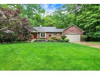 Charming brick home featuring a manicured lawn and lush landscaping at 2143 Sunderland Dr, Martinsville, IN 46151