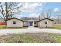 Charming single-story home with a gravel driveway and inviting blue front door at 2420 Goose Creek Rd, Martinsville, IN 46151