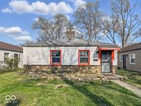 Charming single-story home with stone accents, red window trim, and a cozy front entry at 2429 N Arsenal Ave, Indianapolis, IN 46218