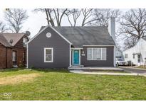 Charming single-story home with gray siding, a gray roof, a bright blue door, and a well-manicured lawn at 3636 N Chester Ave, Indianapolis, IN 46218