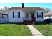 Charming home with a well-maintained front yard and walkway leading to the cozy front porch at 3949 Fletcher Ave, Indianapolis, IN 46203