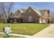 Traditional brick home with a well-manicured lawn, mature trees, and a charming mailbox at 6019 Timberbend Dr, Avon, IN 46123