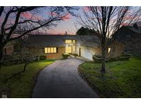 Charming single-Gathering home boasts a brick facade, attached garage, and a curved driveway at 6140 Buttonwood Dr, Noblesville, IN 46062