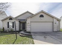 Charming single-story home with brick and siding exterior, well-manicured lawn, and attached two-car garage at 6601 Waterloo Ln, Indianapolis, IN 46268