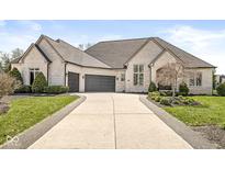 Stunning brick home with a well-manicured lawn and a long driveway leading to a three-car garage at 7259 Josiah Ct, Indianapolis, IN 46259