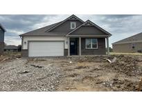 Charming single-story home featuring a brick facade, attached garage and covered entry at 895 Saddlebrook Farms Blvd, Whiteland, IN 46184