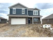 Two-story home with blue siding, brick facade, white trim, and an attached two-car garage. Ready to be lived in at 905 Saddlebrook Farms Blvd, Whiteland, IN 46184