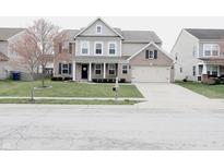 Charming two-story home with a combination of siding and brick, complemented by a well-manicured lawn at 11149 Titania Ct, Noblesville, IN 46060