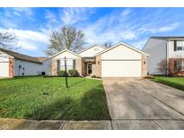 Charming single-Gathering home featuring a well-maintained lawn, a two-car garage and a mix of brick and siding at 12030 Driftstone Dr, Fishers, IN 46037