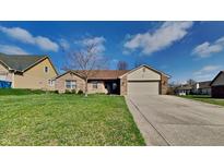 Charming single-story brick home with well-manicured lawn and attached two-car garage at 12334 Buckley Blvd, Indianapolis, IN 46229