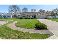 Charming single-story home with stone accents, lush lawn, and a paved walkway at 130 Briarwood Ct, Brownsburg, IN 46112
