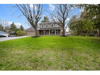 Charming two-story home with a well-manicured lawn and mature trees at 1320 Bittersweet Dr, Greenfield, IN 46140