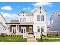 Charming two-story home with white siding, black trim, inviting front porch, and manicured landscaping at 1395 Chatham Hills Blvd, Westfield, IN 46074