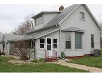Charming home with a gable roof, gray siding, and well-maintained landscaping, offering classic appeal at 1700 S Perdieu Rd, Muncie, IN 47302