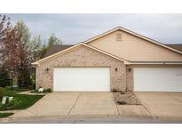 Two-car attached garage with brick facade and white doors offers ample parking and curb appeal at 172 Arabian Ct, Whiteland, IN 46184