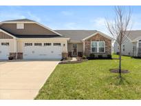 Charming single-story home with a well-manicured lawn and attached two-car garage at 181 Kiawah Dr, Whiteland, IN 46184