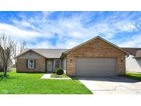 Charming single-story home with brick accents and a well-manicured lawn on a sunny day at 2167 W Autumn Ln, Columbus, IN 47201