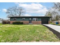 Inviting exterior of a one-story home featuring a well-maintained lawn and attached garage at 232 Bertha Ct, Indianapolis, IN 46241
