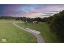 Striking single-story home on a large lot featuring a winding driveway and beautiful landscaping at 2428 S Morgantown Rd, Greenwood, IN 46143