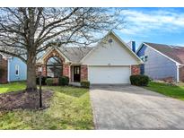 Charming single-Gathering home with a well-manicured lawn and attached two-car garage at 36 Palomino Ct, Zionsville, IN 46077